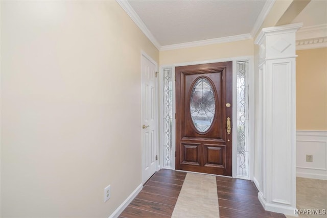 entryway with crown molding, dark wood-type flooring, and ornate columns