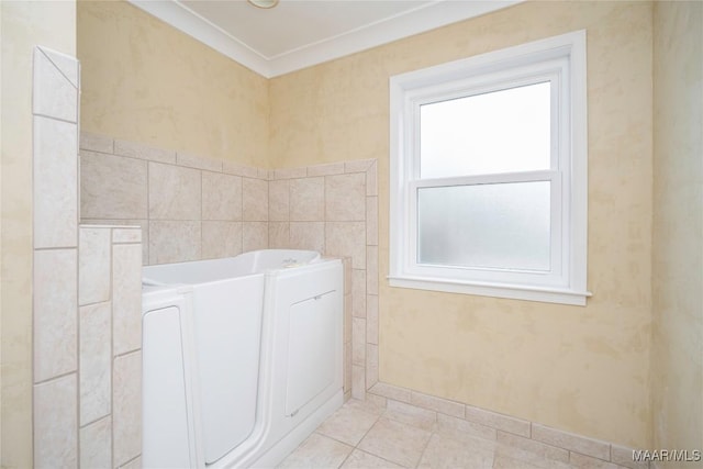 bathroom with washer / clothes dryer, crown molding, a washtub, and tile patterned floors