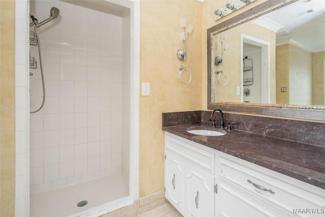 bathroom with vanity, tile patterned floors, and a tile shower