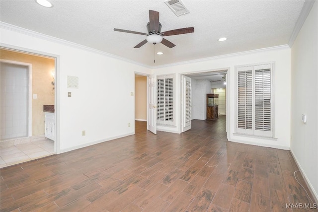 spare room with ceiling fan, crown molding, and a textured ceiling