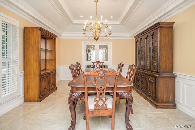 dining area with a raised ceiling, ornamental molding, light tile patterned floors, and a notable chandelier