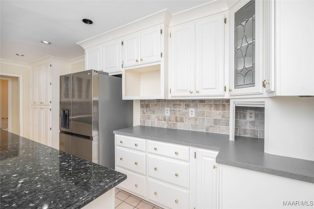 kitchen featuring tasteful backsplash, crown molding, white cabinets, and stainless steel refrigerator with ice dispenser