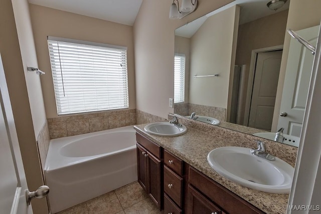 bathroom with tile patterned flooring, vanity, and separate shower and tub