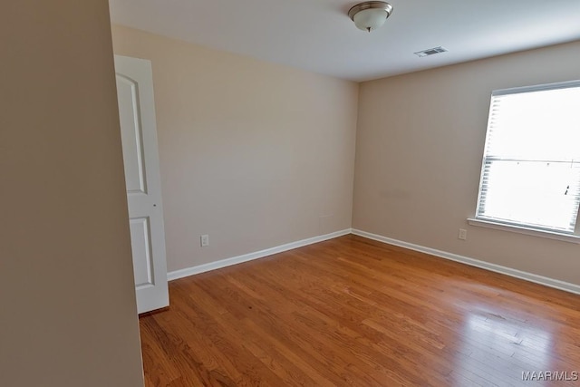 unfurnished room with plenty of natural light and light hardwood / wood-style floors