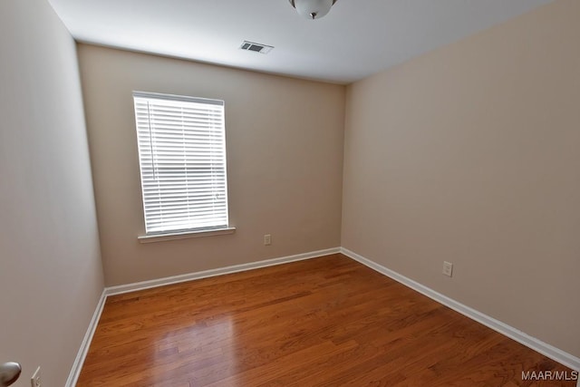 empty room with hardwood / wood-style flooring