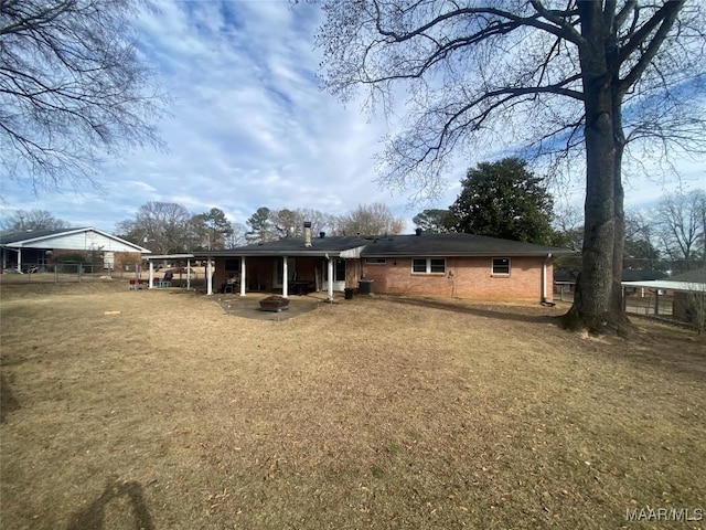 back of property featuring a lawn