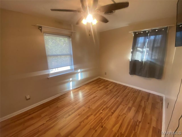 spare room featuring hardwood / wood-style floors and ceiling fan