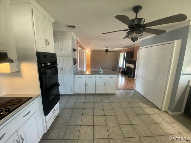 kitchen with white cabinetry, extractor fan, ornamental molding, black appliances, and light tile patterned flooring