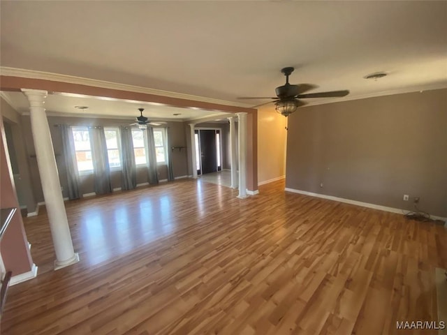 interior space featuring hardwood / wood-style floors, crown molding, decorative columns, and ceiling fan