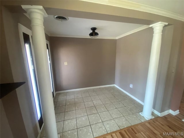 unfurnished dining area featuring light tile patterned flooring, ornamental molding, and ornate columns