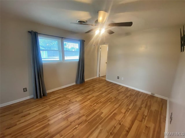 empty room featuring ceiling fan and light wood-type flooring