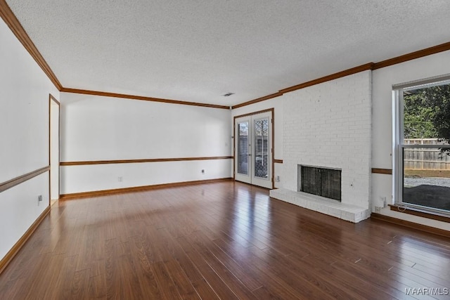 unfurnished living room with hardwood / wood-style floors, crown molding, a fireplace, and a textured ceiling