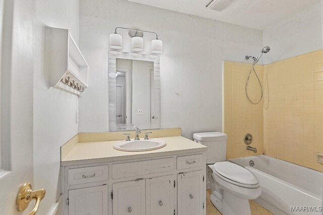 full bathroom featuring vanity, toilet, and tiled shower / bath combo