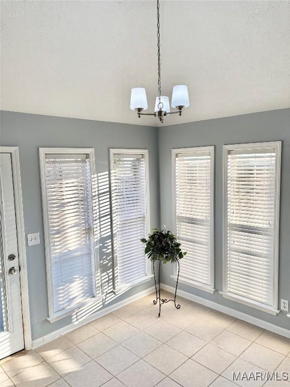 dining space featuring plenty of natural light and light tile patterned floors