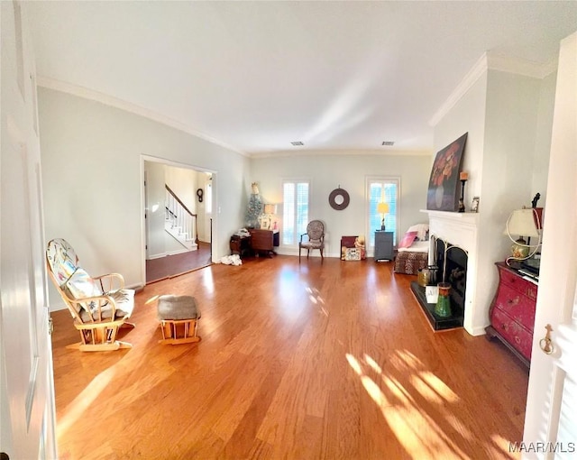 living room featuring crown molding and hardwood / wood-style flooring