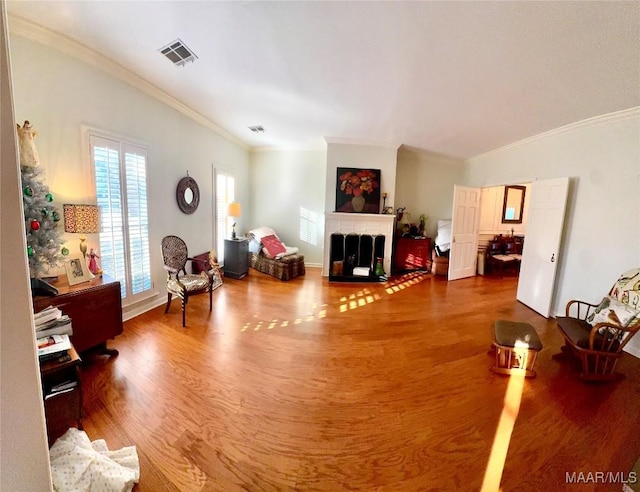 living room with ornamental molding and hardwood / wood-style floors