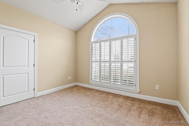 carpeted spare room with lofted ceiling and ceiling fan