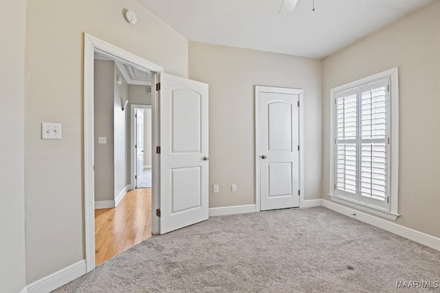 unfurnished bedroom with light colored carpet and ceiling fan