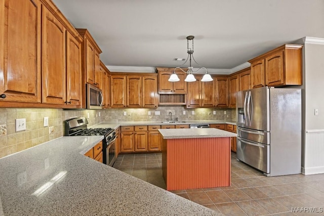 kitchen featuring sink, a kitchen island, light stone countertops, and appliances with stainless steel finishes