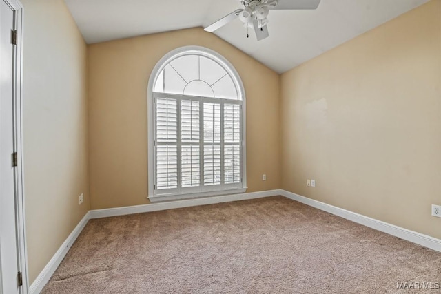 unfurnished room featuring lofted ceiling, ceiling fan, and carpet