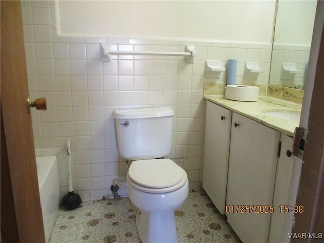 bathroom with vanity, tile patterned floors, and tile walls