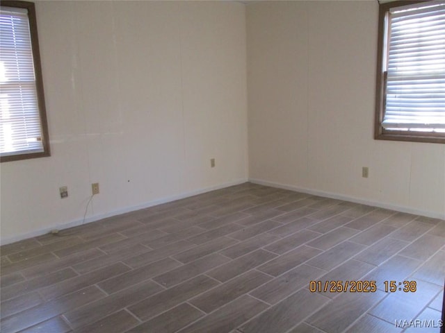 empty room with dark hardwood / wood-style flooring