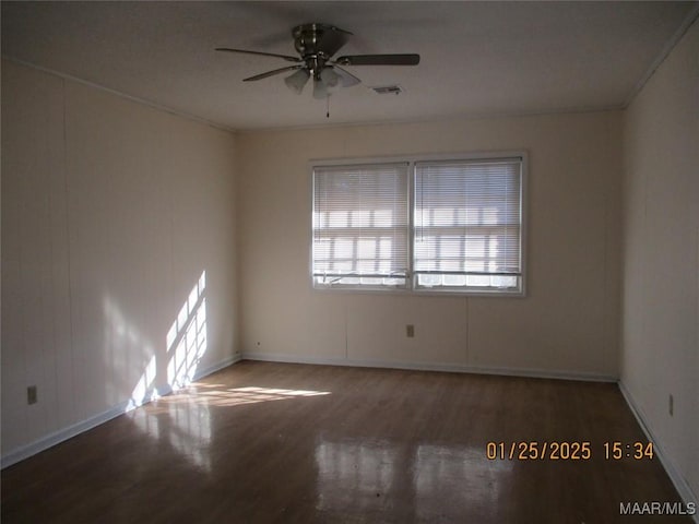 unfurnished room with dark wood-type flooring, ornamental molding, and ceiling fan