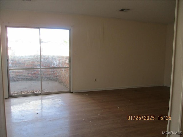 spare room with hardwood / wood-style floors