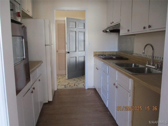 kitchen featuring sink, white cabinetry, white refrigerator, gas cooktop, and dark hardwood / wood-style flooring