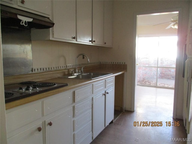 kitchen featuring white cabinetry, sink, backsplash, and gas cooktop