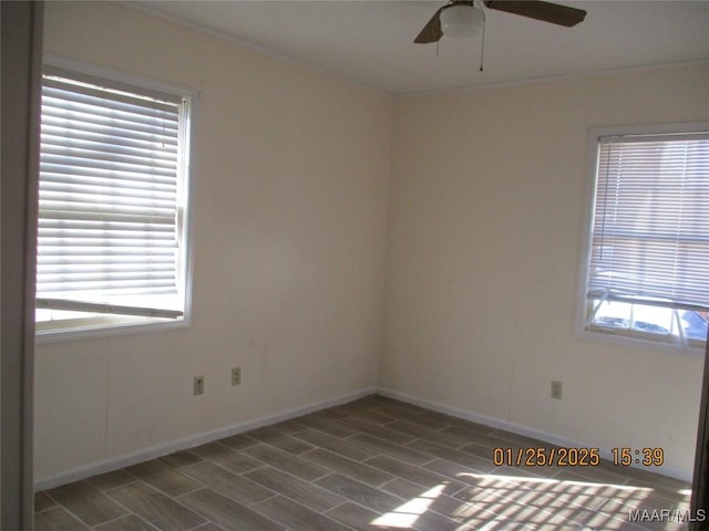 unfurnished room with a wealth of natural light, dark hardwood / wood-style floors, and ceiling fan