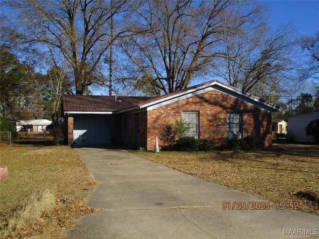 ranch-style home featuring a front yard and a carport