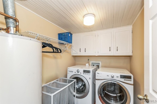 laundry room with cabinets, gas water heater, and independent washer and dryer