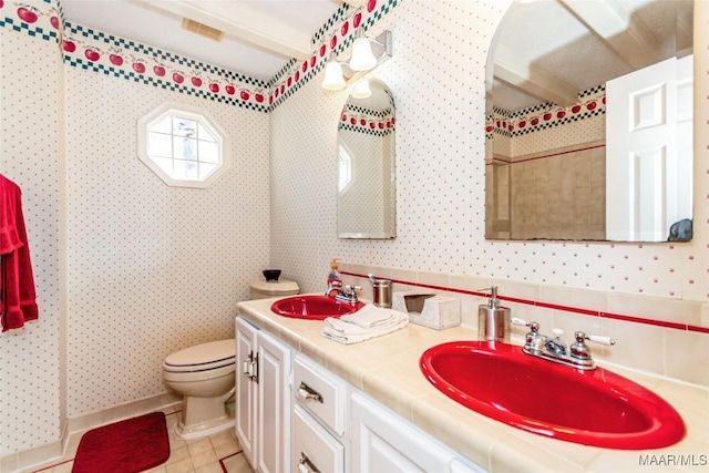 bathroom featuring vanity, tile patterned floors, and toilet