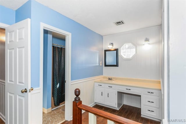 bathroom with hardwood / wood-style flooring, vanity, and a shower with curtain