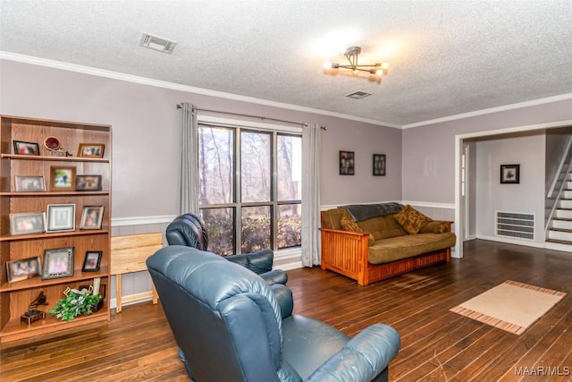 living room with dark wood-type flooring, crown molding, and a textured ceiling