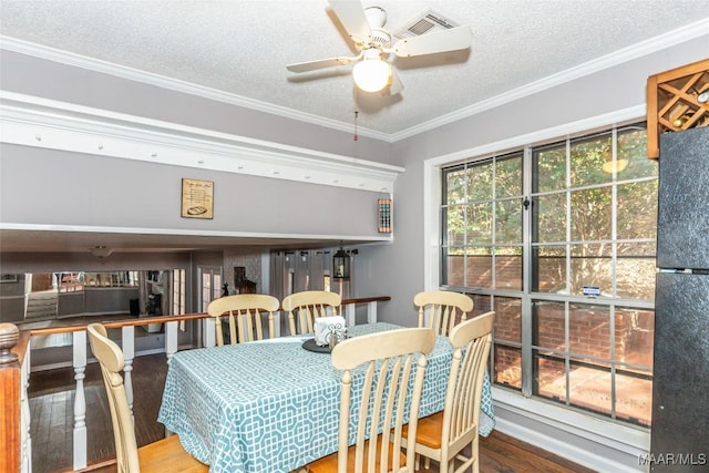 dining space with hardwood / wood-style flooring, ceiling fan, crown molding, and a textured ceiling