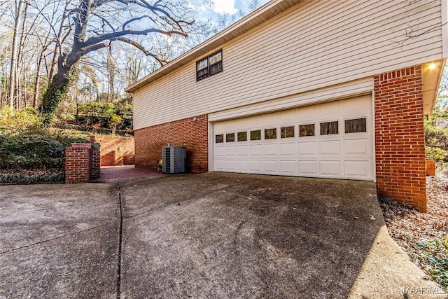 view of home's exterior featuring a garage and central AC unit