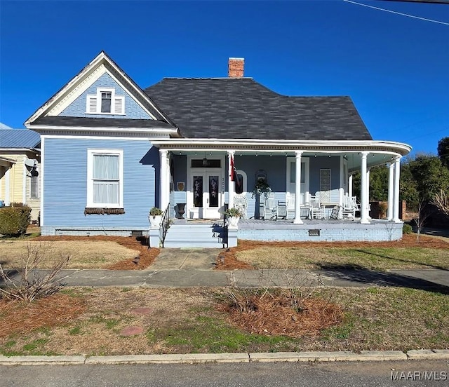 view of front facade with french doors and covered porch