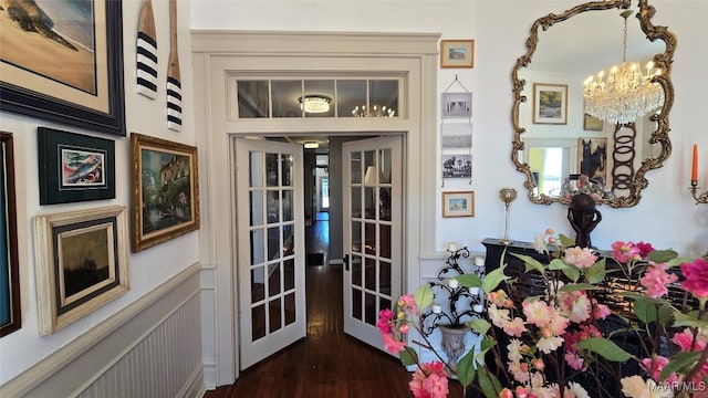 interior space featuring french doors, dark hardwood / wood-style floors, and a notable chandelier