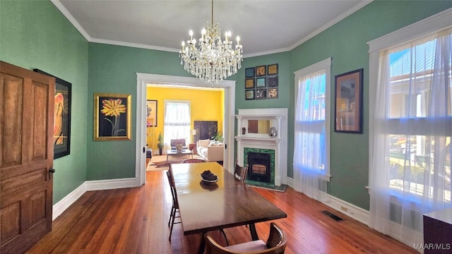 interior space with dark hardwood / wood-style floors, ornamental molding, plenty of natural light, and a fireplace