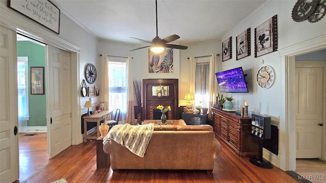 living room featuring crown molding, dark hardwood / wood-style floors, and ceiling fan