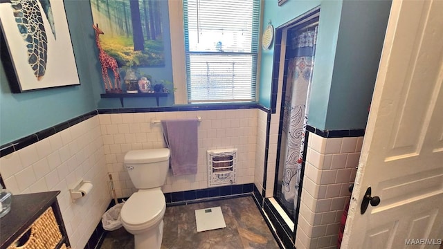 bathroom with tile walls, vanity, heating unit, and toilet