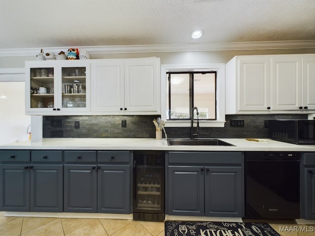 kitchen featuring light countertops, glass insert cabinets, white cabinets, a sink, and black appliances