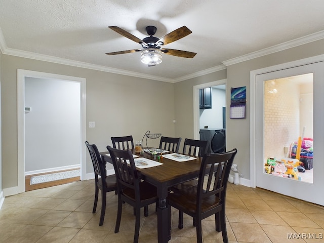 dining room with light tile patterned floors, ornamental molding, and baseboards