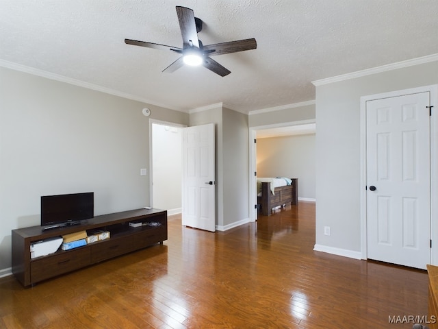 unfurnished bedroom with dark wood-style floors, ornamental molding, a textured ceiling, and baseboards