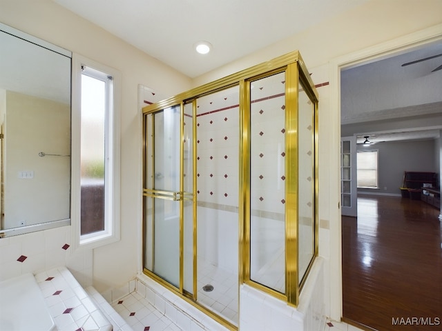 full bathroom with wood finished floors and a tile shower