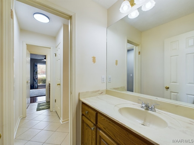 bathroom with tile patterned flooring, vanity, and baseboards