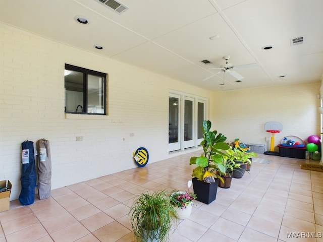 view of patio / terrace with ceiling fan and visible vents