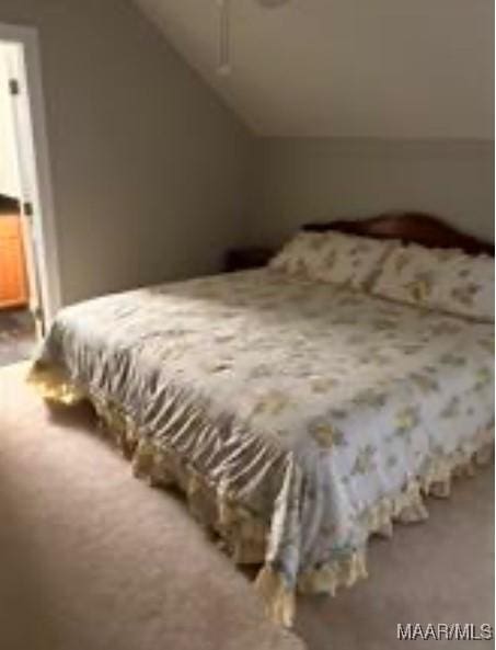 carpeted bedroom featuring lofted ceiling